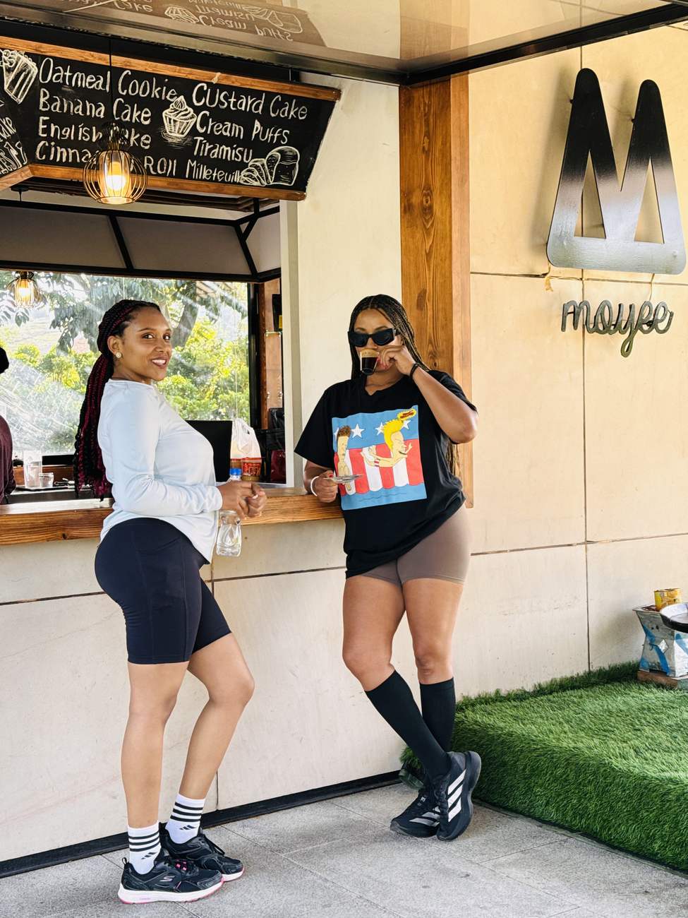 Two members standing at a coffee window after a run