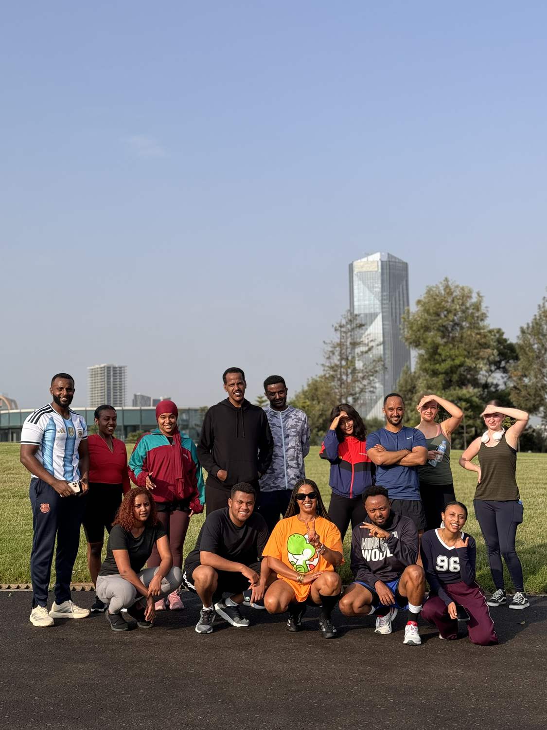 The club together on the grass with the city skyline behind